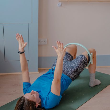 A person on the floor doing pilates.