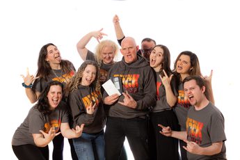 Group of people wearing We Will Rock You T-shirts.