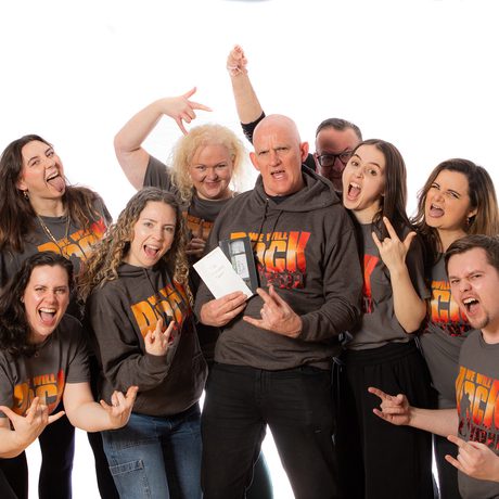Group of people wearing We Will Rock You T-shirts.