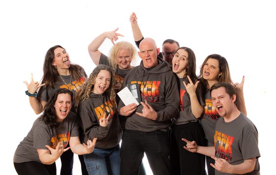 Group of people wearing We Will Rock You T-shirts.