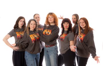 Group of people wearing We Will Rock You T-shirts.