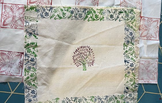 Printed decorated fabric squares laid out.