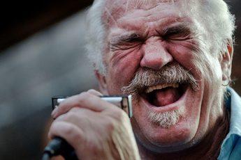 A close up of a person singing into a microphone.