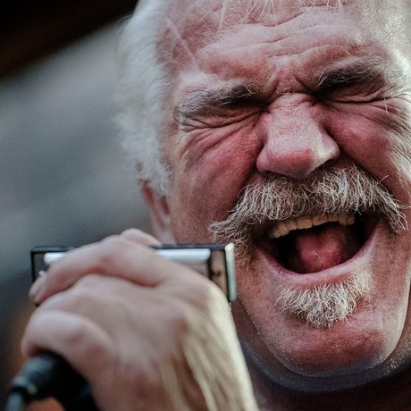 A close up of a person singing into a microphone.