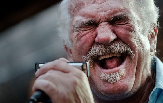 A close up of a person singing into a microphone.
