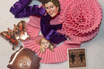 A craft item made if ribbons and photos in pink and purple.