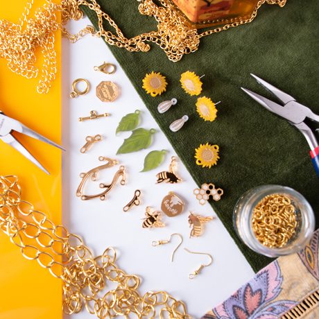 Jewellery making equipment and materials, featuring leaves, sunflowers and bees.