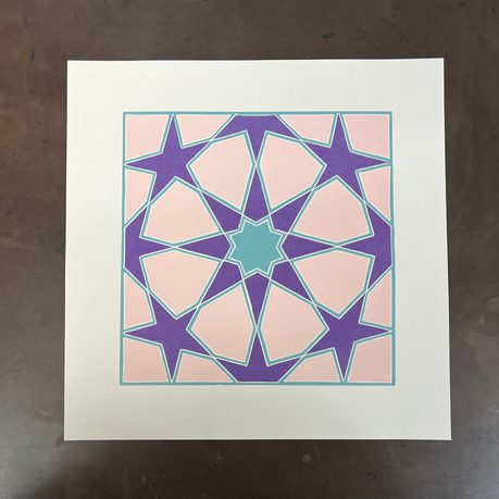 A lino print of a star design.