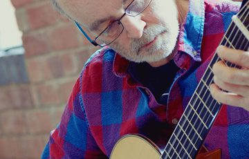 A man playing a guitar.