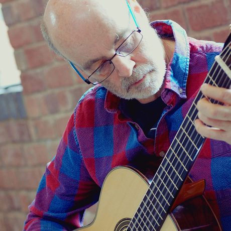 A man playing a guitar.