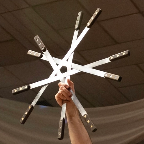 Hand holding metal in the shape of a star.