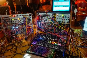 A collection of equipment, colourful wires and screens.