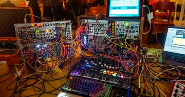 A collection of equipment, colourful wires and screens.