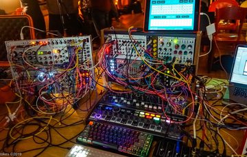 A collection of equipment, colourful wires and screens.