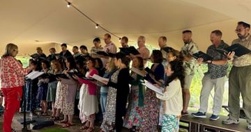 A group of people singing in a choir.