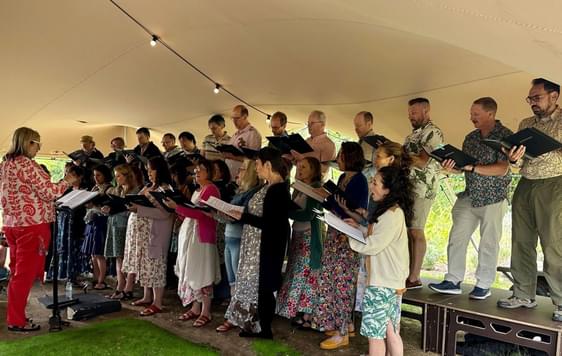 A group of people singing in a choir.