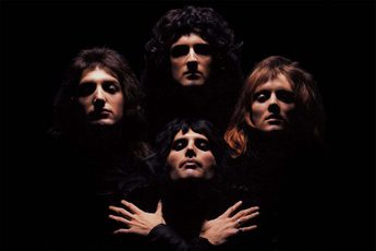 Picture of heads of three men at the top and one below with hands crossed against his chest against a black background