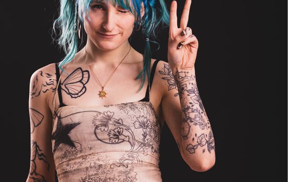 Portrait photograph of lady with blue hair with the text "Featuring Astrid Solace".