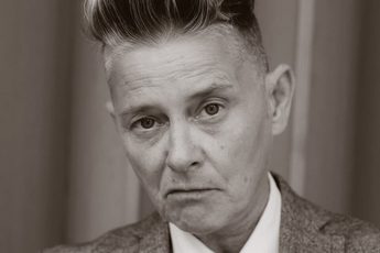 Black and white photo of a person wearing a suit.
