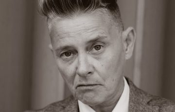 Black and white photo of a person wearing a suit.