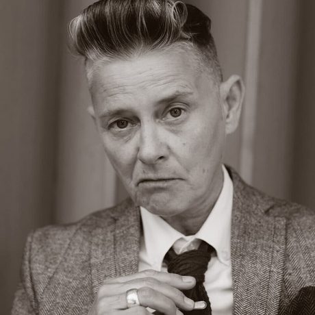 Black and white photo of a person wearing a suit.