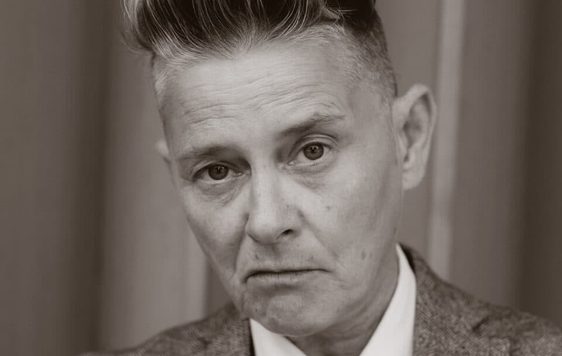 Black and white photo of a person wearing a suit.