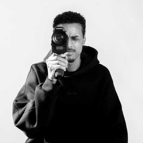 Black and white photo of a man holding a camera.