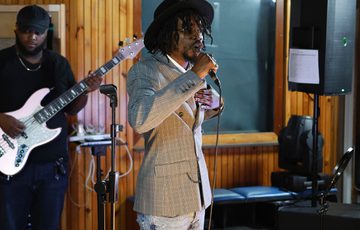 A person standing in a room with a microphone.