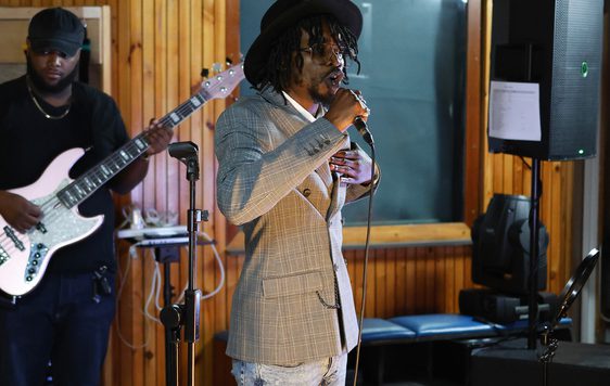 A person standing in a room with a microphone.