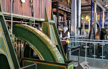 A person dressed as alien Roswell character looking at the machinery at Thinktank.