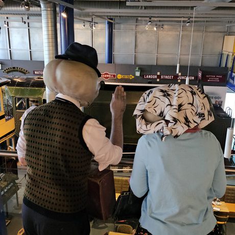 The back of heads of two people dressed as alien Roswell characters.