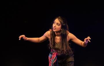 A dancer dancing on stage.