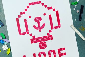 Printed artwork made from LEGO shapes of a dogs head that says woof.