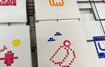 Artwork prints made from LEGO pieces in the shapes of bird and cat.