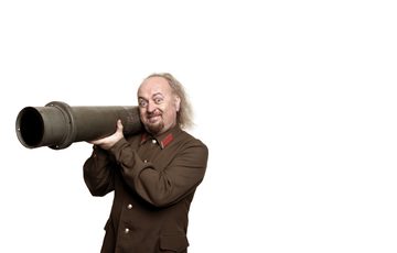 A man dressed in an army uniform holding a pipe against a white background