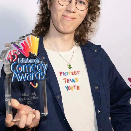 Sam Nicoresti holding an award.