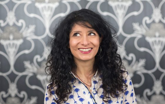 Shappi Khorsandi head shot looking up to the left.