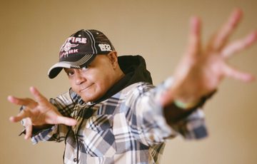 Nik Coppin with hands out in front.