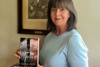 An author holding a her book.
