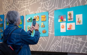 A person taking a photograph of the Historic Yardley display.