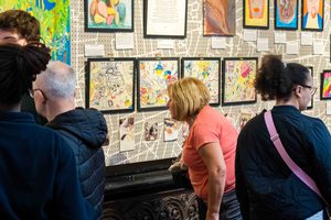 A member of the public views artwork created by Citizens of Midland Mencap at the Birmingham Museum and Art Gallery exhibition.