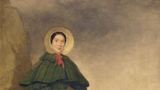 A painting of a lady standing outside, she wears a green dress with bonnet and holds a hammer or tool and carries a basket.  She is standing next to a large rock and the sea behind her. A dog is curled up at her feet.
