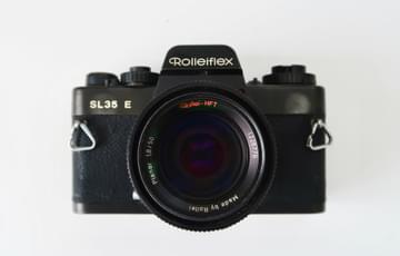 A Rolleiflex camera taken head one, with an off-white background