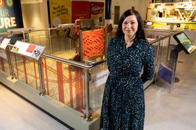 Sarah Rea Land standing next to the gasholders exhibition at Thinktank