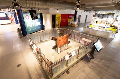 The Gas holder exhibition with the giant metal plate in the centre and display boards around the edge