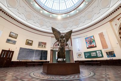 The round gallery with Lucifer at the centre and artworks hanging on the walls.