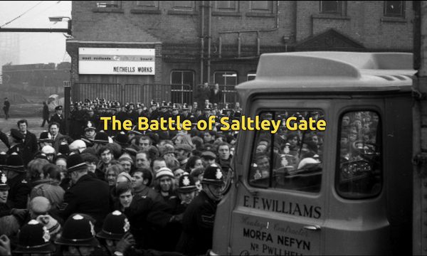 A black and white image showing a large number of picketers and policemen.