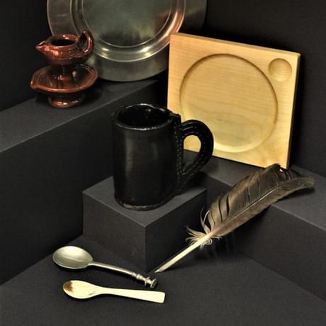 Tudor items including mug, spoons, quill pen, plate