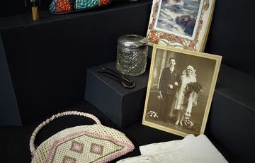 Lady's shoe, bag, gloves plus a historic photo of a person on their wedding day.