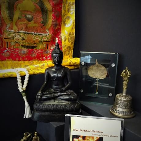 Buddhist items including Prayer beads, Guanyin statue, Buddha Rupa, embroidery, bell, fragment of frieze, bodhi leaf.